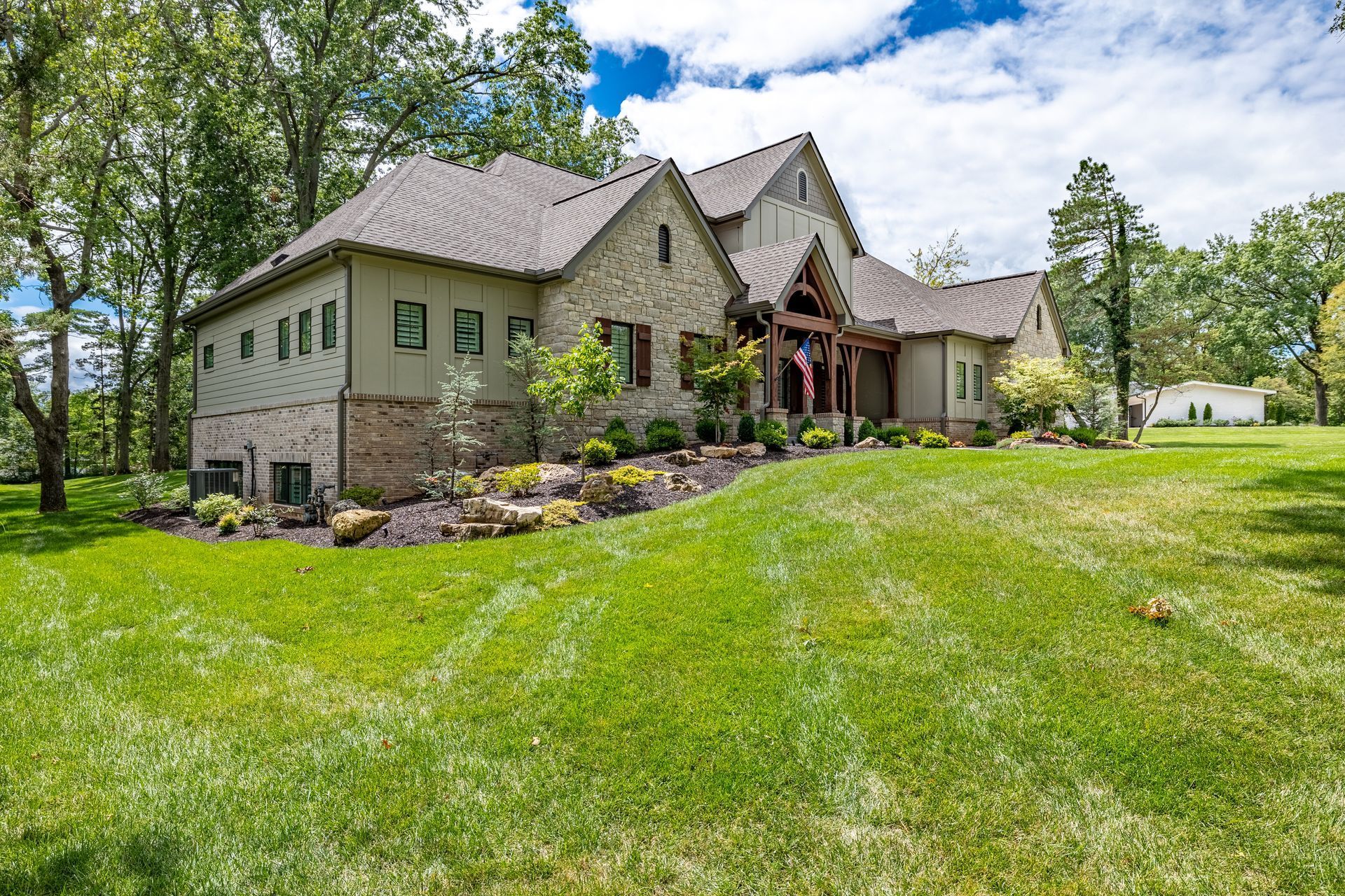 A large house with a lush green lawn in front of it.