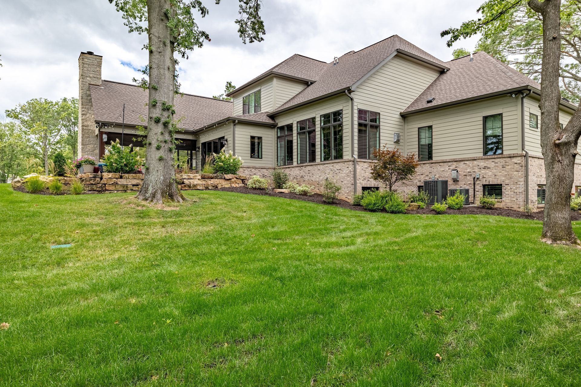 A large house with a lush green lawn in front of it.