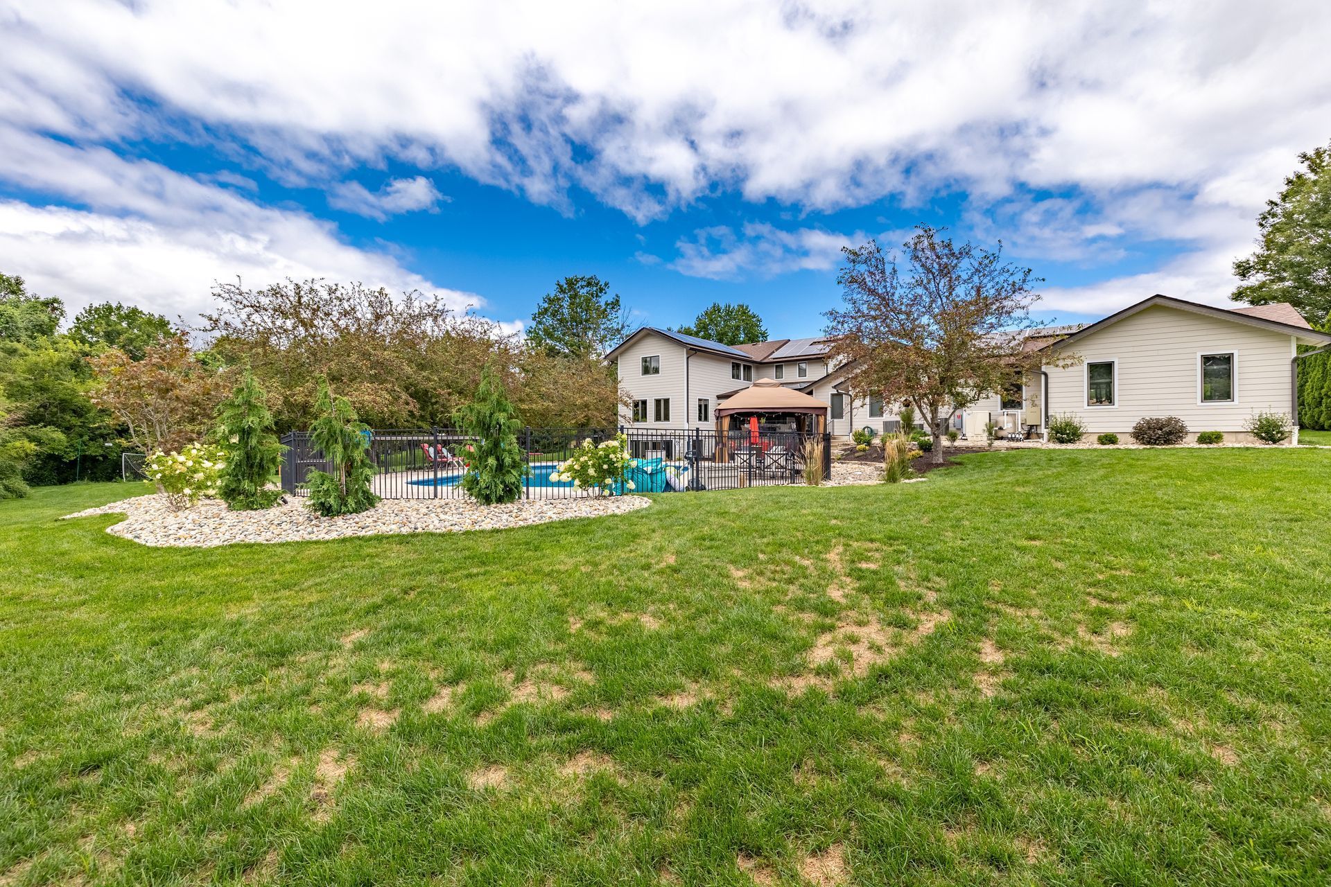 A large house with a large lawn in front of it.