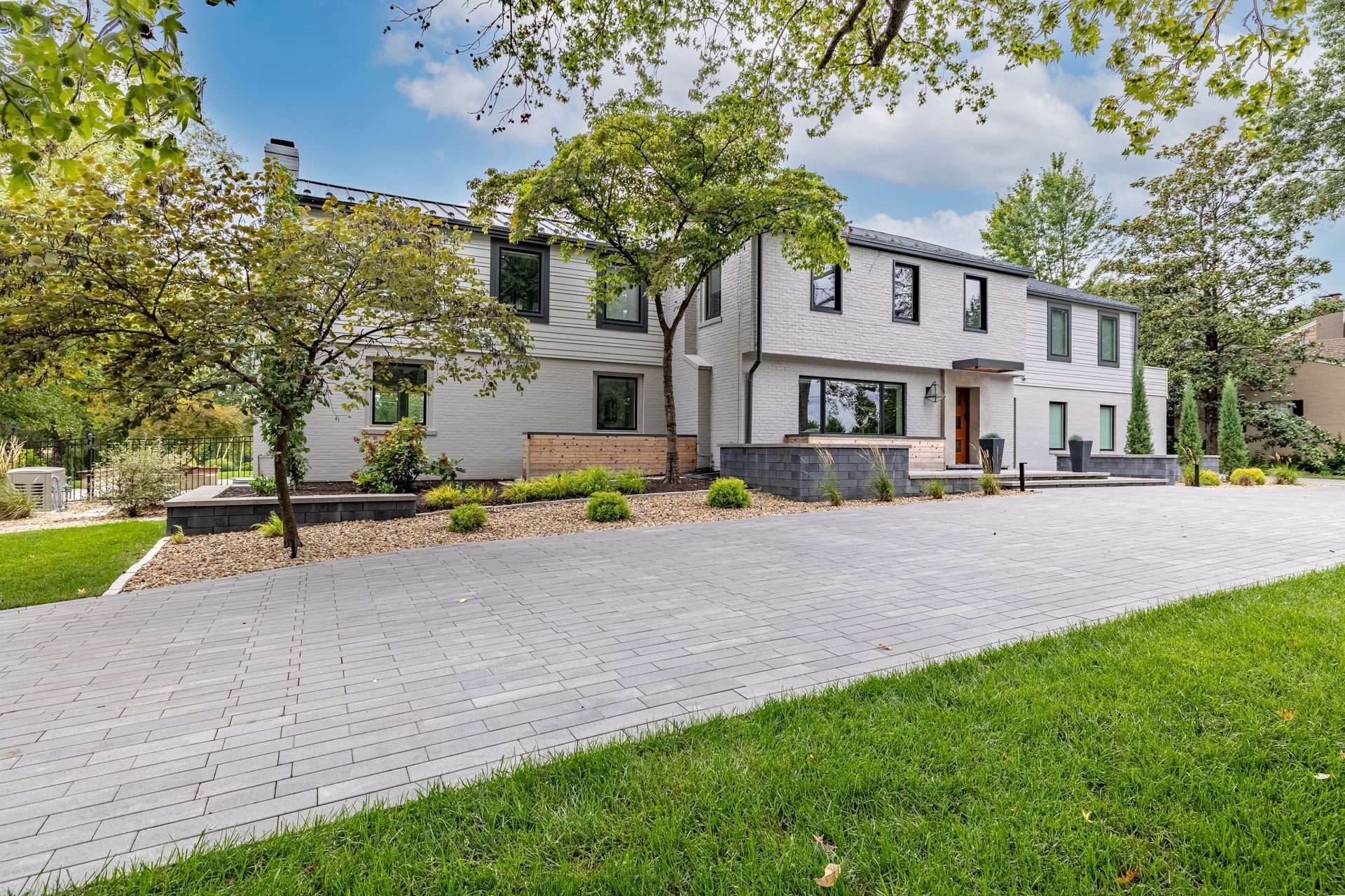 A large white house with a driveway leading to it