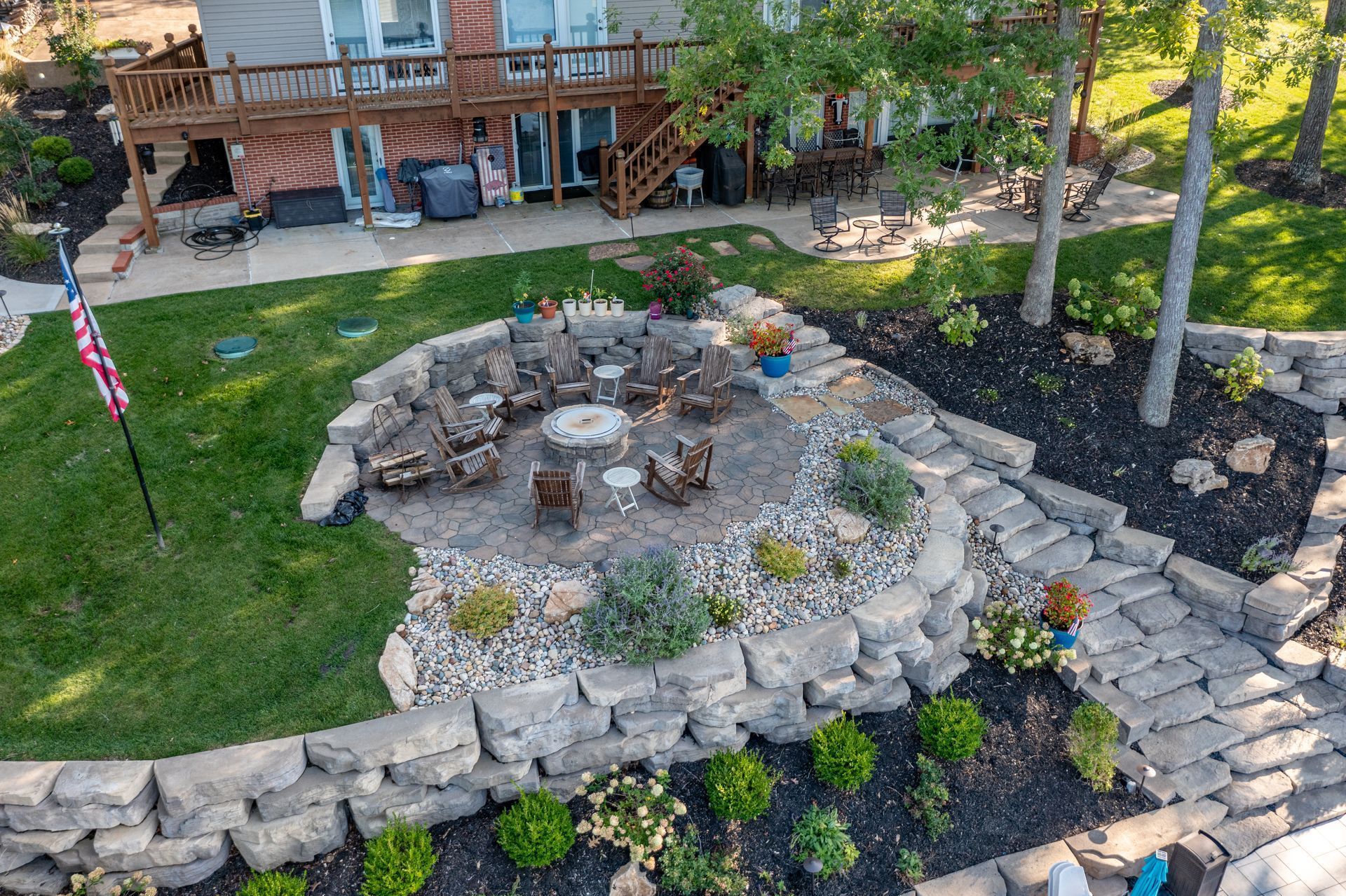 An aerial view of a fire pit in the backyard of a house.