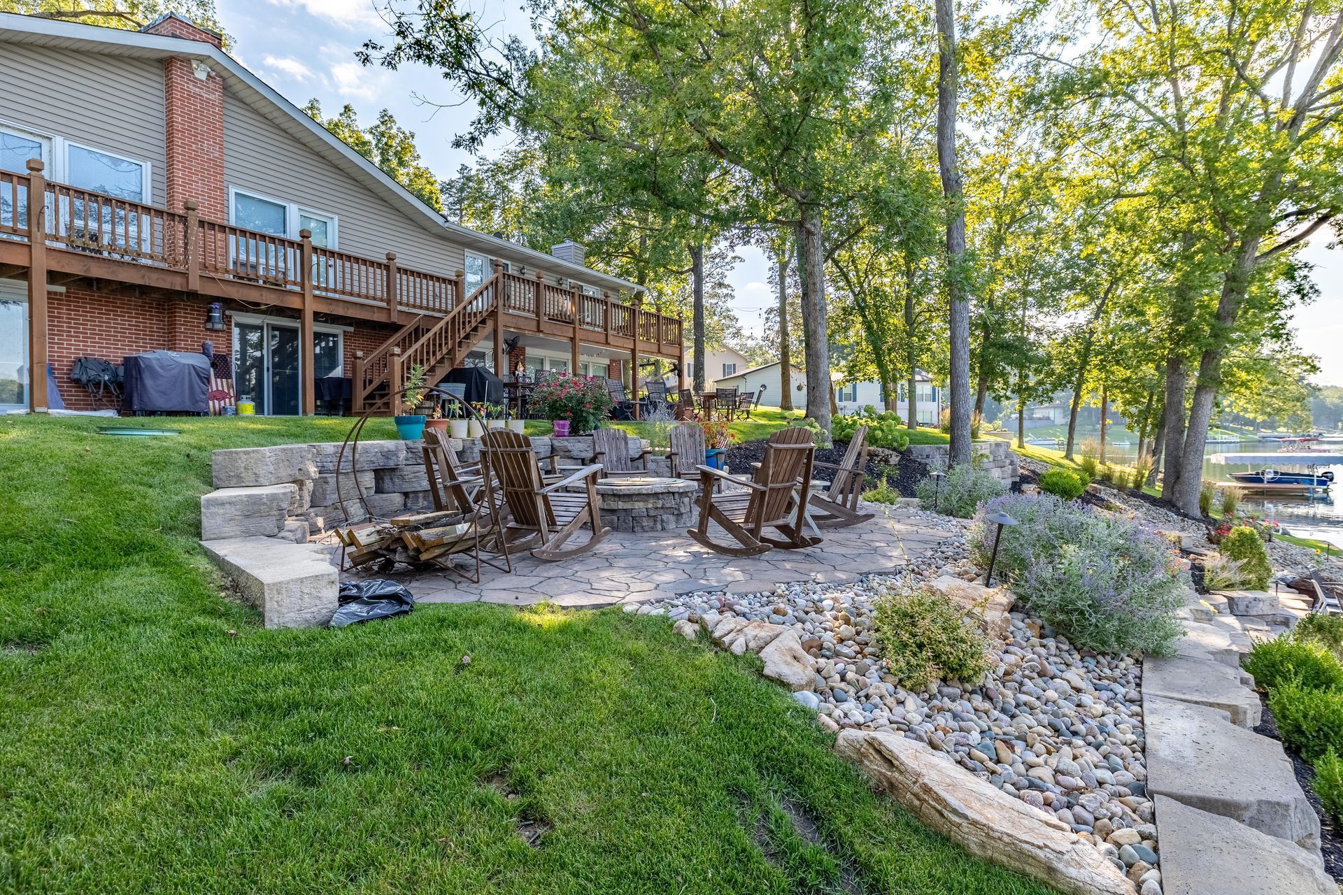 A large house with a patio and a fire pit in front of it.