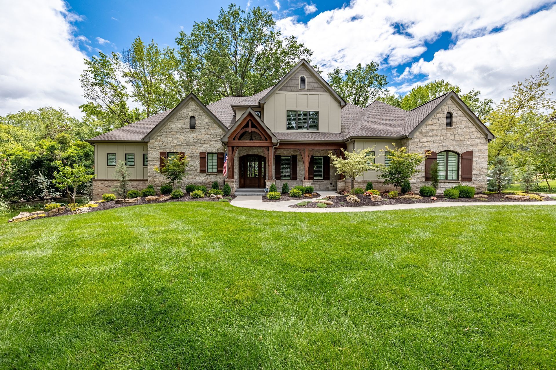A large house with a lush green lawn in front of it.
