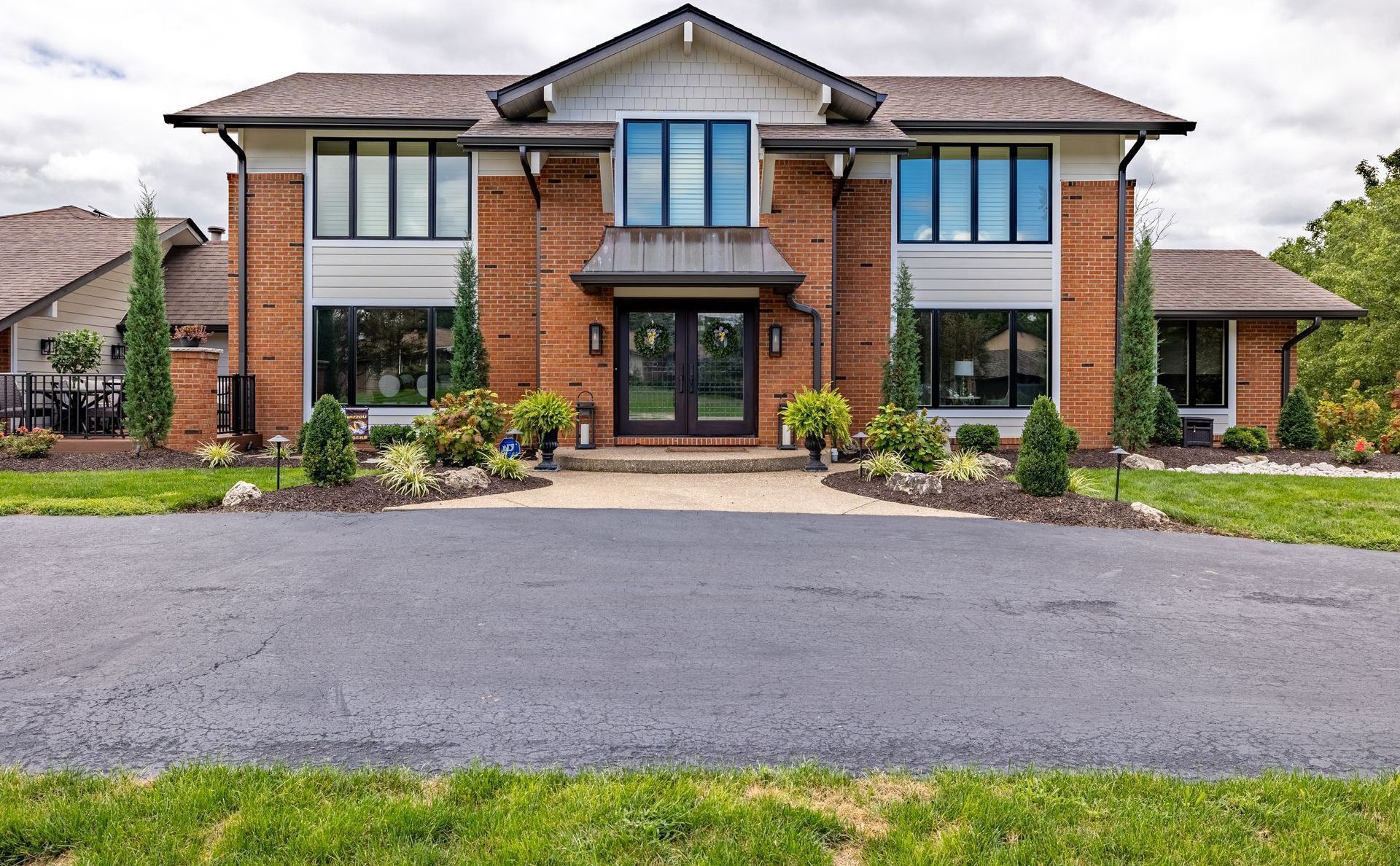 A large brick house with a driveway in front of it
