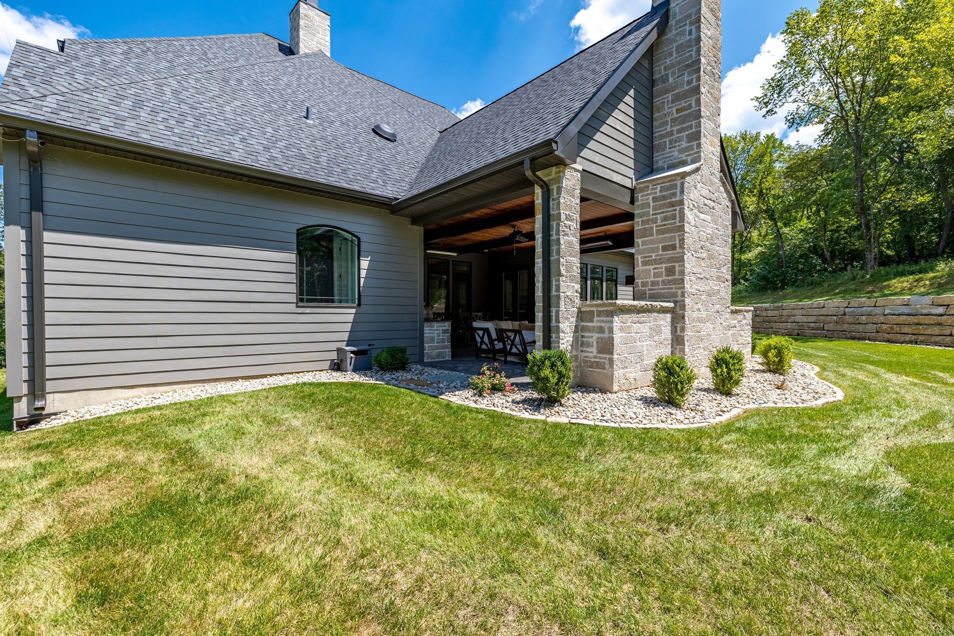 A large house with a lush green lawn in front of it.