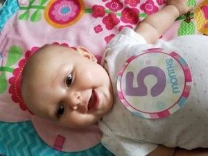 a baby is wearing a shirt that says 5 months on it