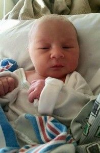 a newborn baby is laying in a hospital bed .