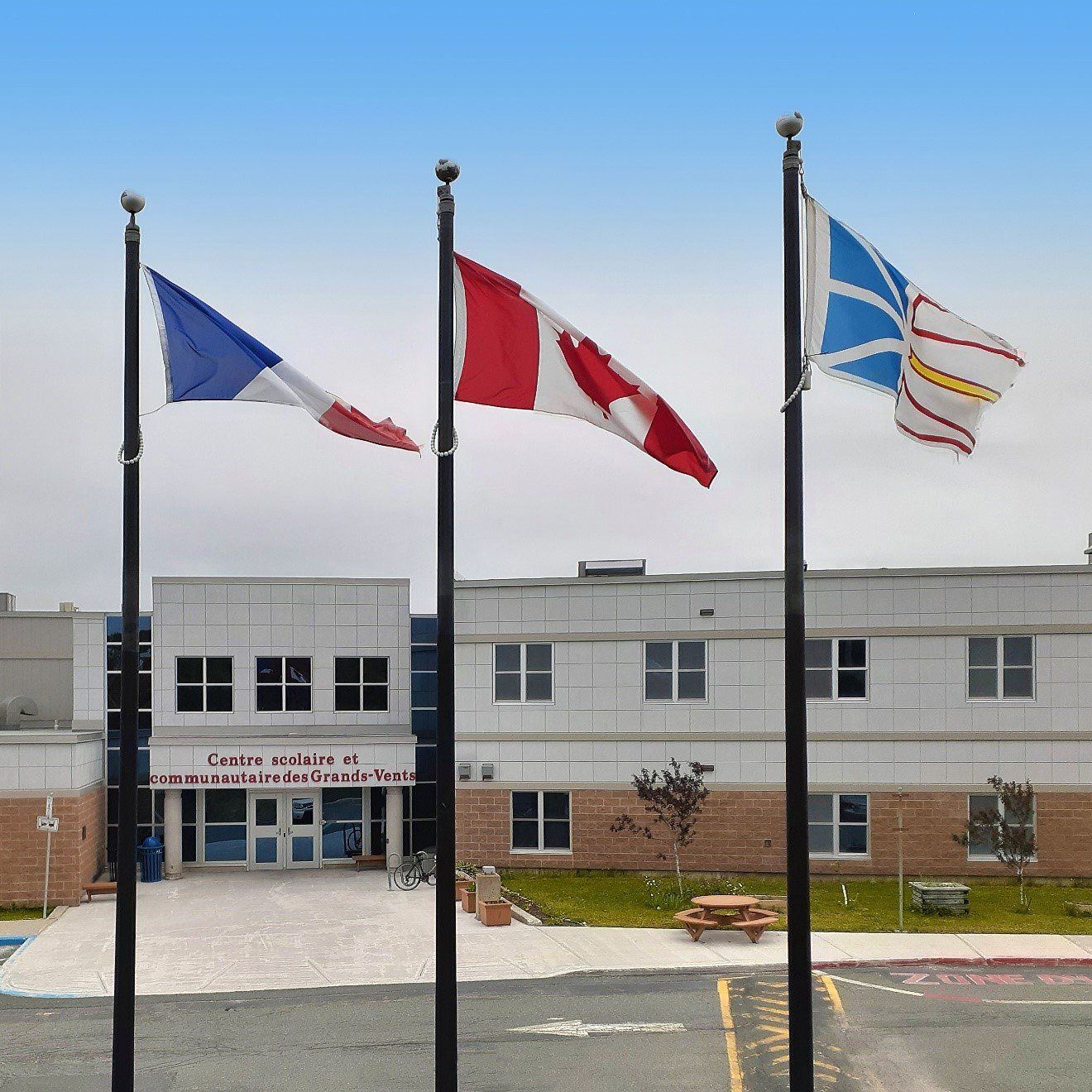 Flags in front of the entrance to the Centre scolaire et communautaire des Grands-Vents.