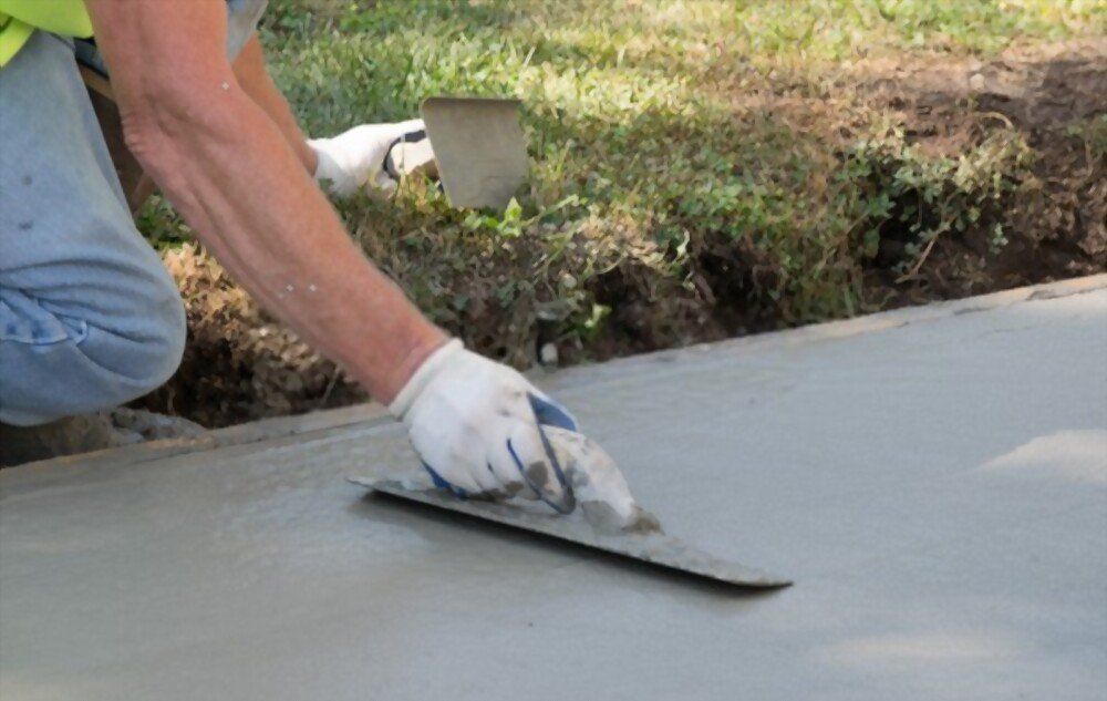 Lely FL contractor using bullnose flooring trowel to level the concrete patio surface