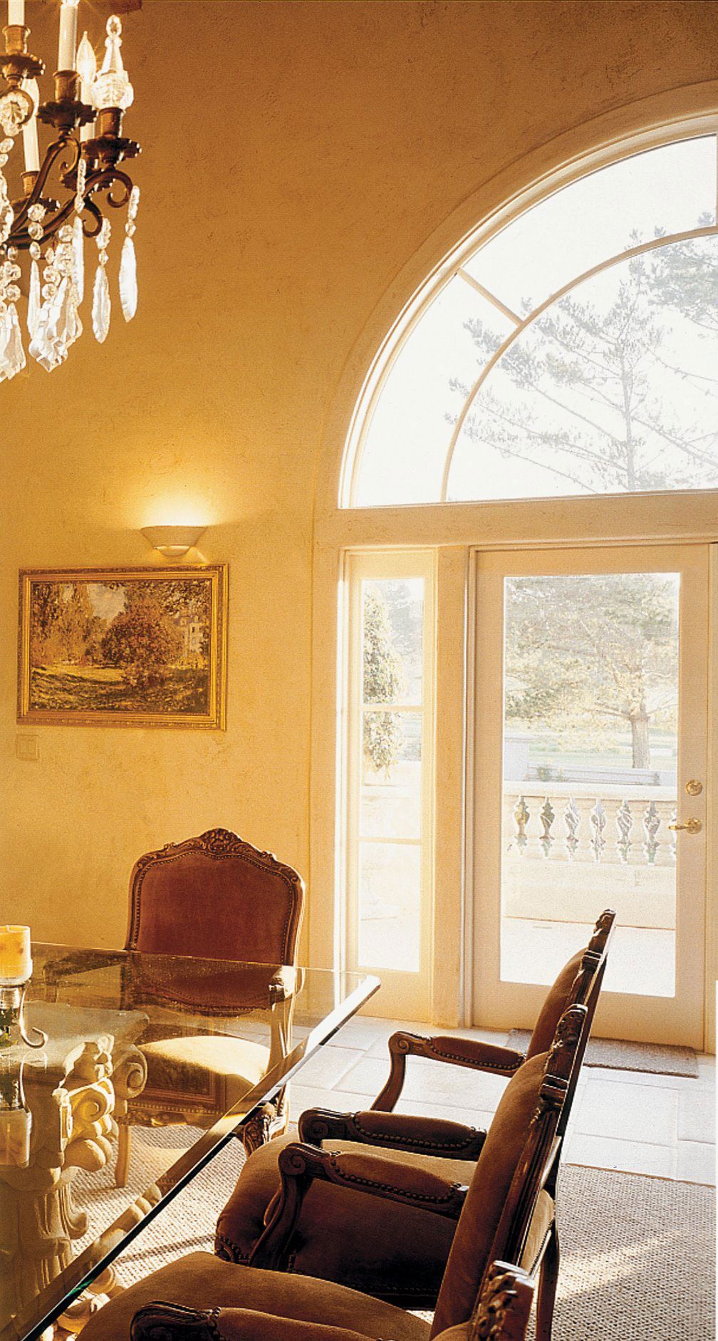 A dining room with a glass table and chairs