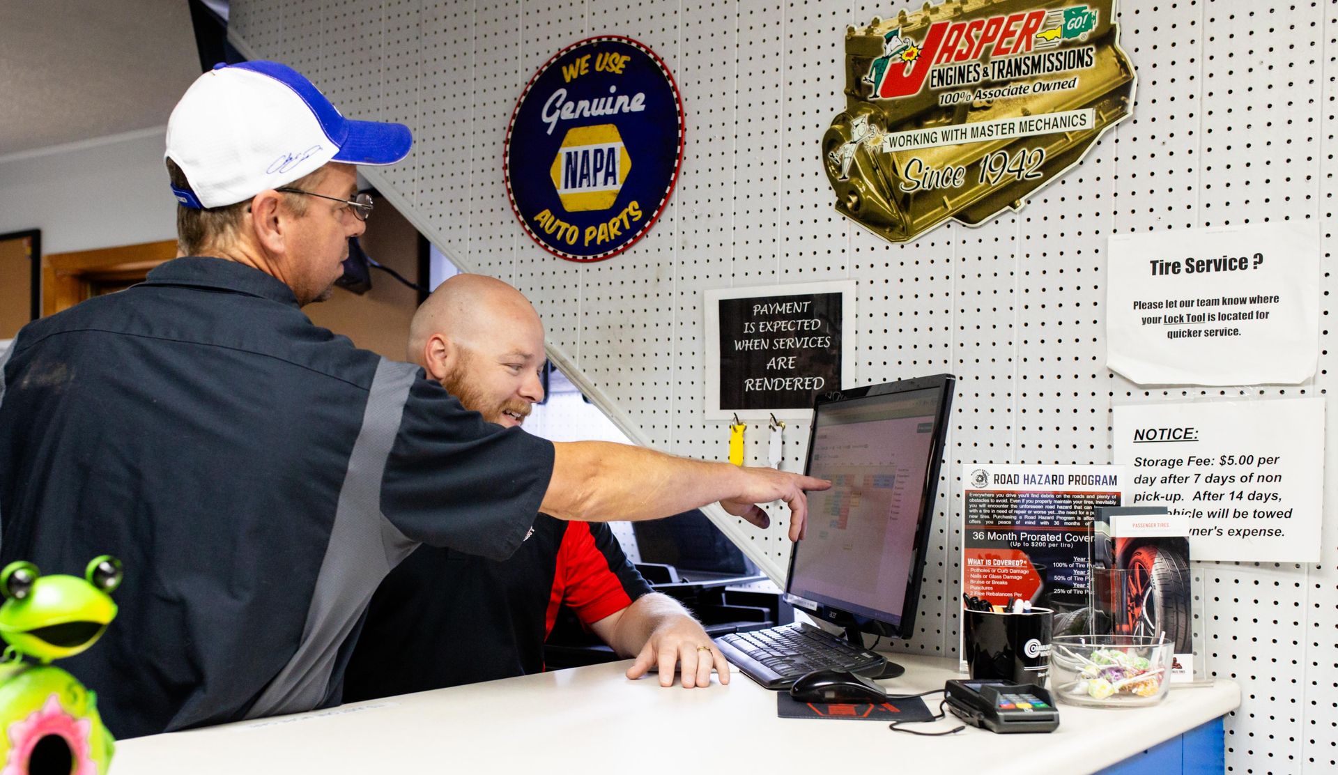 Two men at a computer in an auto shop | Modern Brake & Alignment
