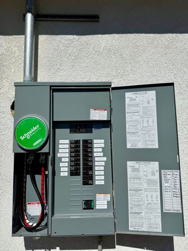 Man using a tool to work on electrical components inside a control panel.