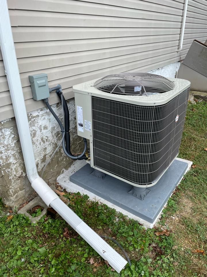 Large air conditioner sitting on the side of a house — Bensalem, PA — D.N.A Heating & Air