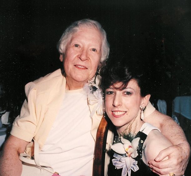 An older woman and a younger woman are posing for a picture