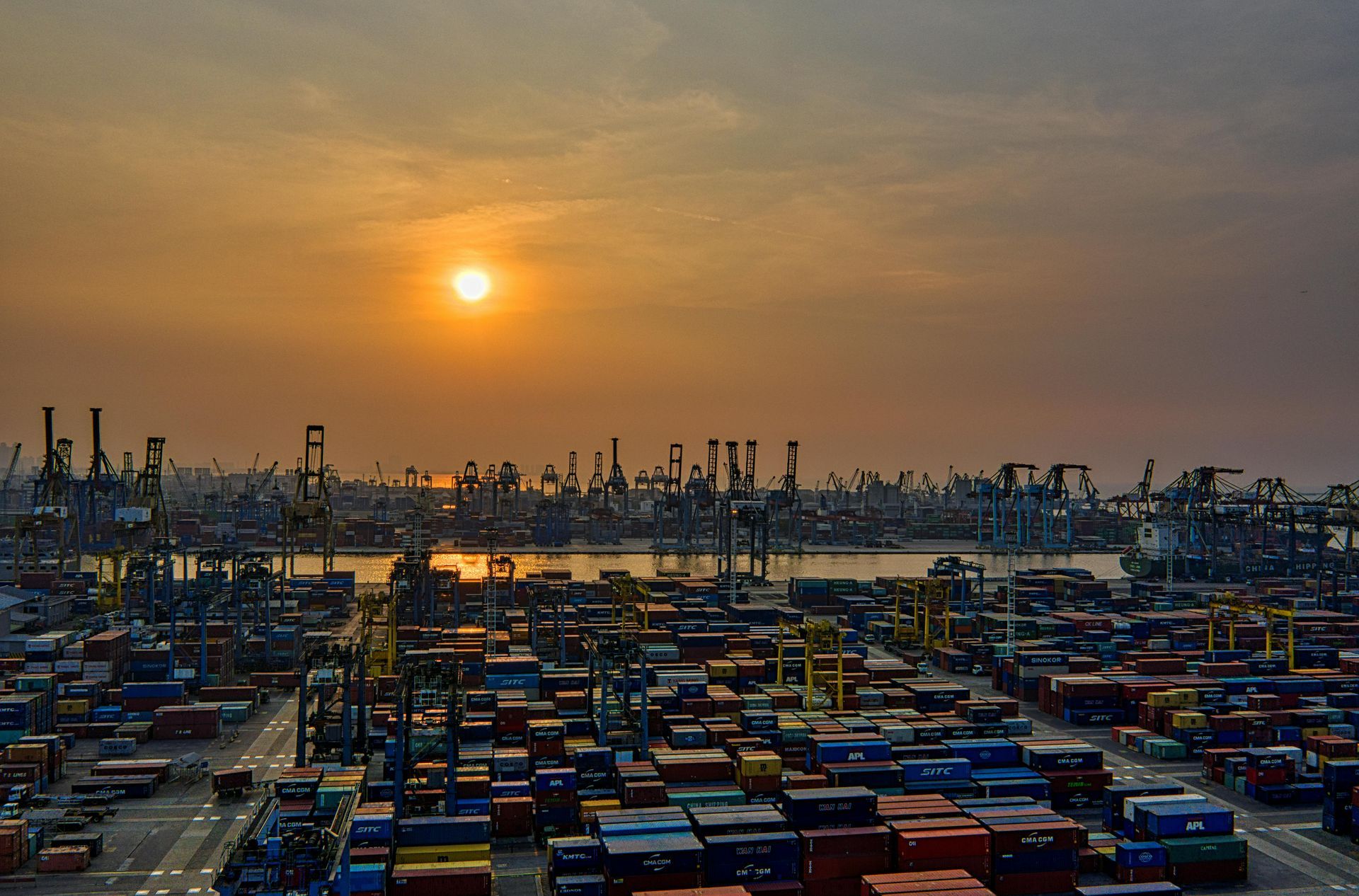 A port with containers at sunrise
