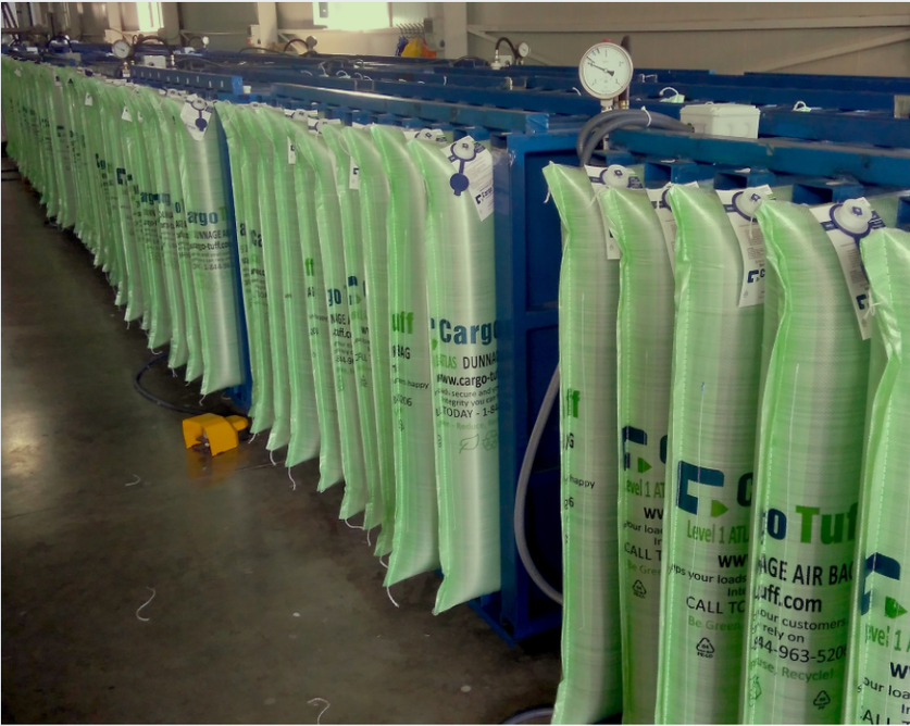 A row of green bags with the word cargo on them