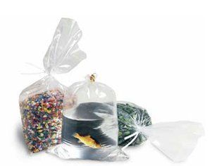 A fish is in a clear plastic bag next to a bag of sprinkles.