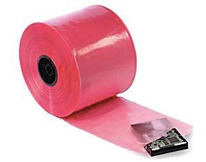 A roll of pink plastic bags is sitting on a white surface.