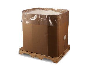 A large cardboard box is sitting on top of a wooden pallet.