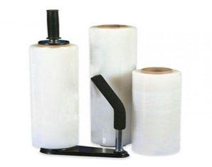 Three rolls of plastic wrap and a plastic wrap dispenser on a white background.
