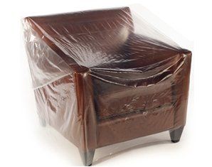 A brown leather chair with a clear plastic cover on it