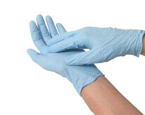 A person is putting on a pair of blue gloves