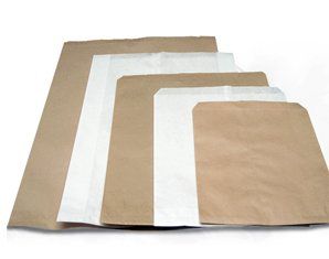 A group of brown and white paper bags are stacked on top of each other.