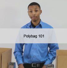 A man in a blue shirt is standing in front of cardboard boxes.