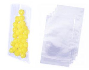 A bunch of yellow balls are in a clear plastic bag.