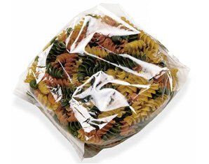 A bag of mixed spiral pasta is wrapped in plastic.