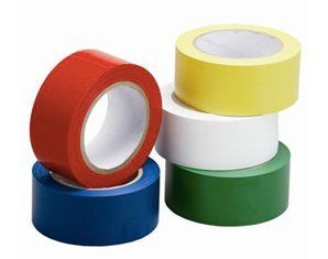 Four rolls of colorful tape are stacked on top of each other on a white background.