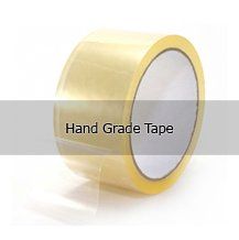 A roll of hand grade tape is sitting on a white surface.