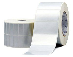Two rolls of labels are sitting next to each other on a white surface.