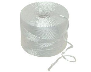 A close up of a spool of white rope on a white background.