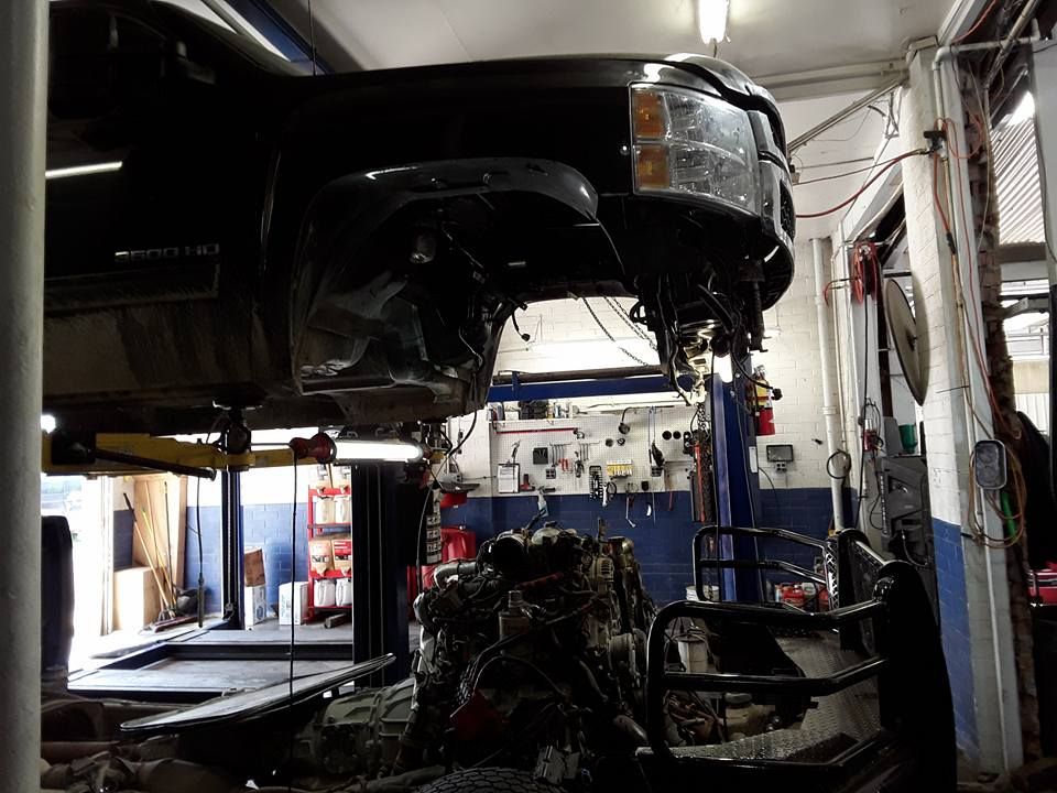 Car On Lift During Engine Repair | Ric Henry Auto Service