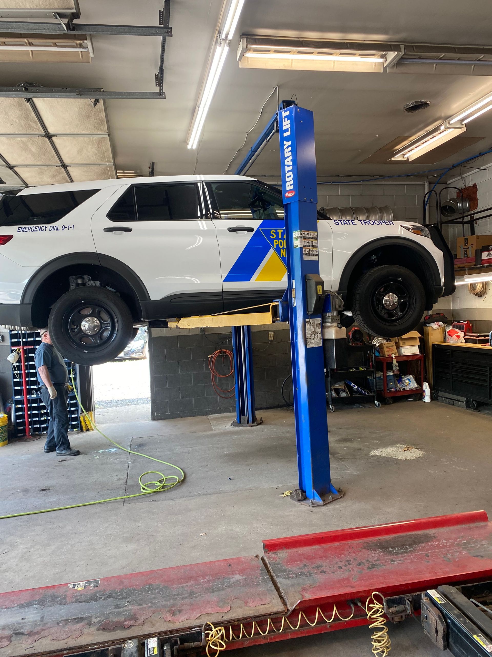 white suv on lift | Red Lion Express Lube And Auto Repair