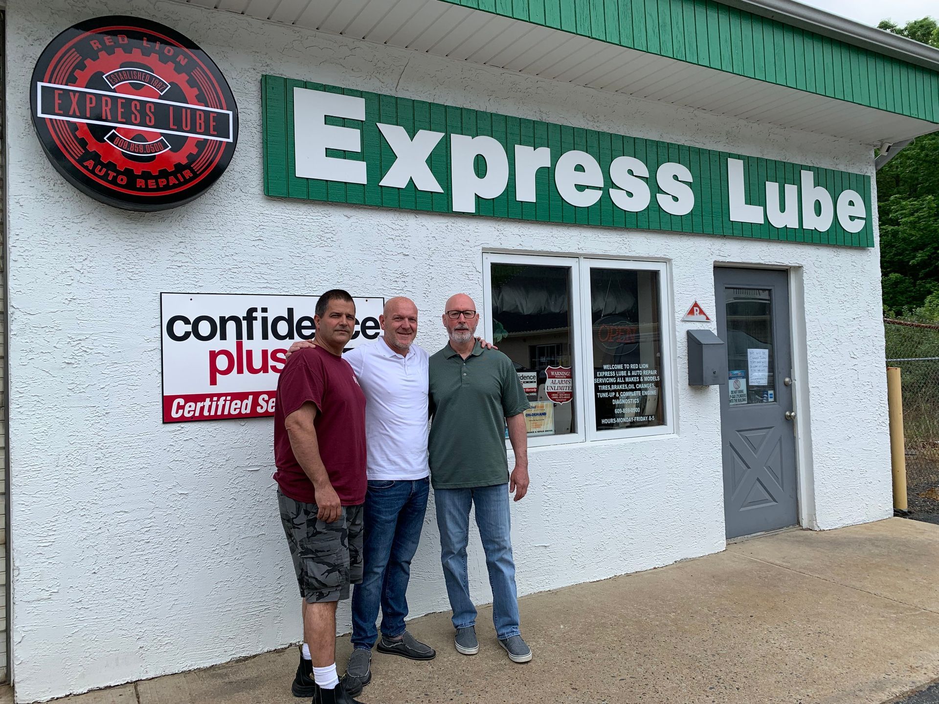 mechanic team in front of shop | Red Lion Express Lube And Auto Repair