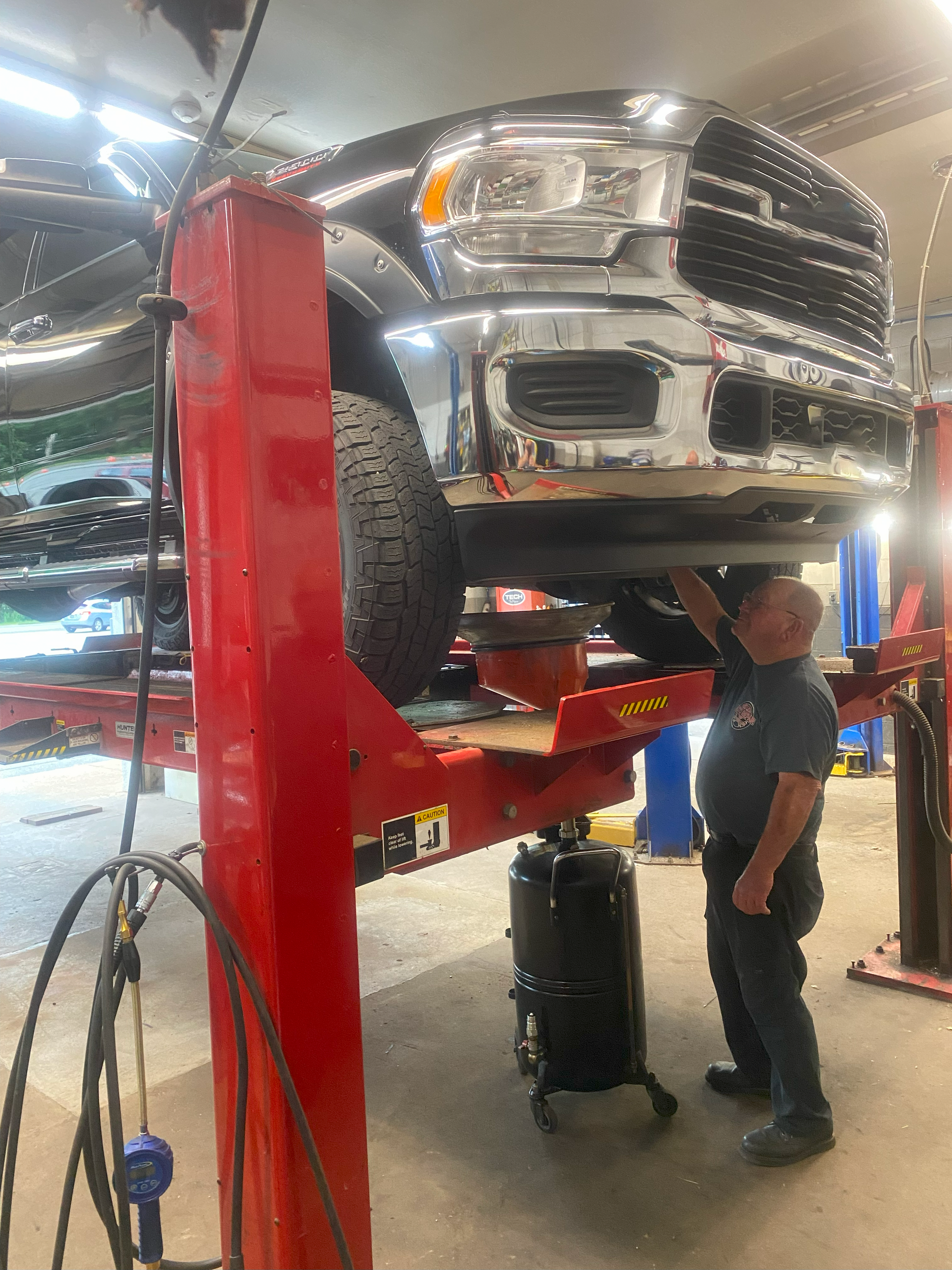 mechanic working on truck on lift | Red Lion Express Lube and Auto