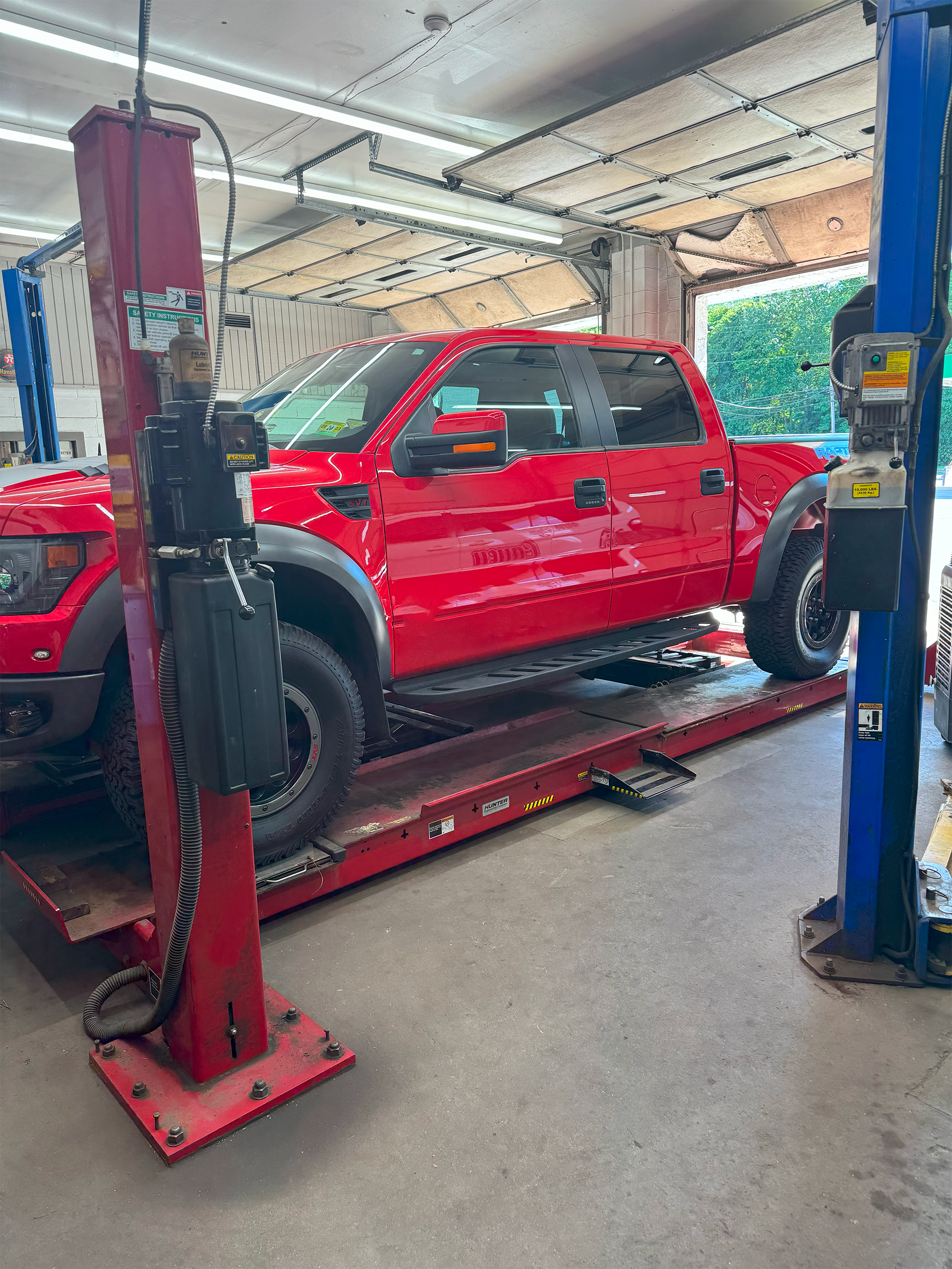red truck on lift | Red Lion Express Lube and Auto