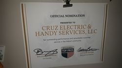 A certificate for cruz electric & handy services , llc is hanging on a wall.
