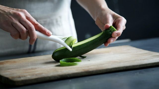 Man Peeling Cucumber