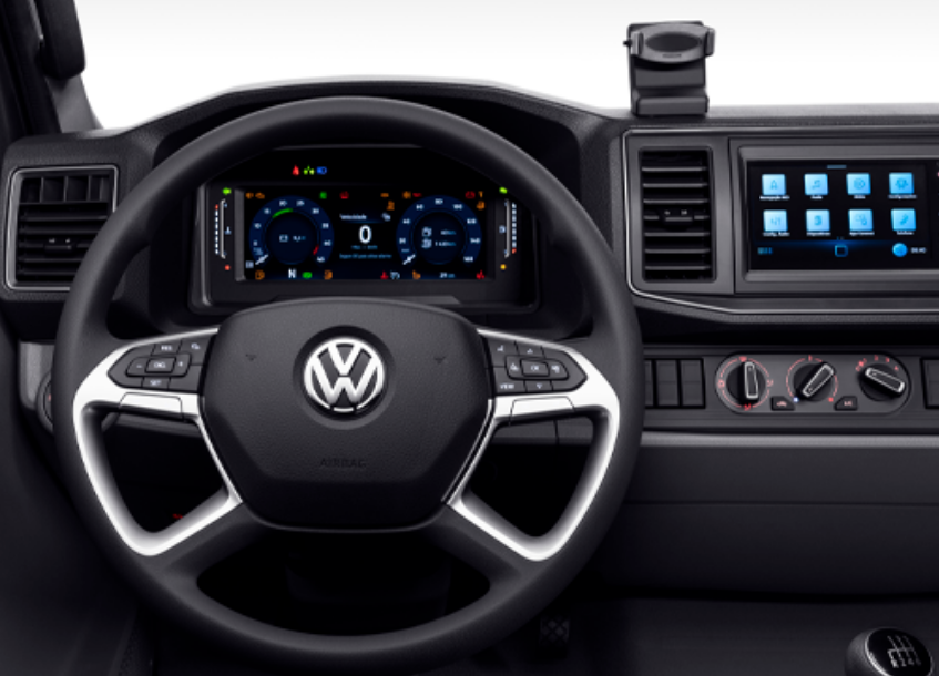 El interior de un camión Volkswagen con volante y tablero de instrumentos.