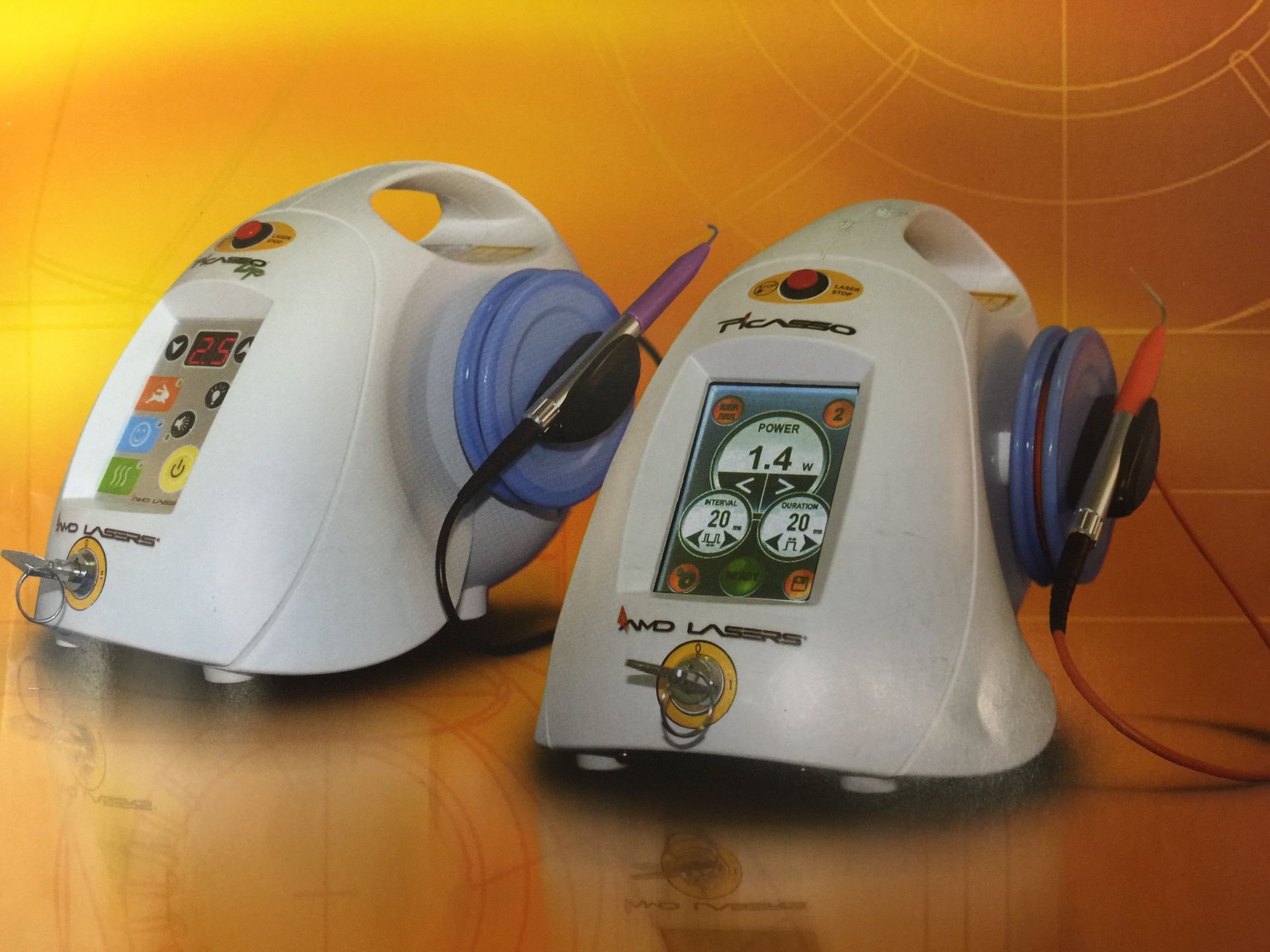 Two IWO Laser devices with white, rounded housings and digital displays, set against a warm, orange-toned background.