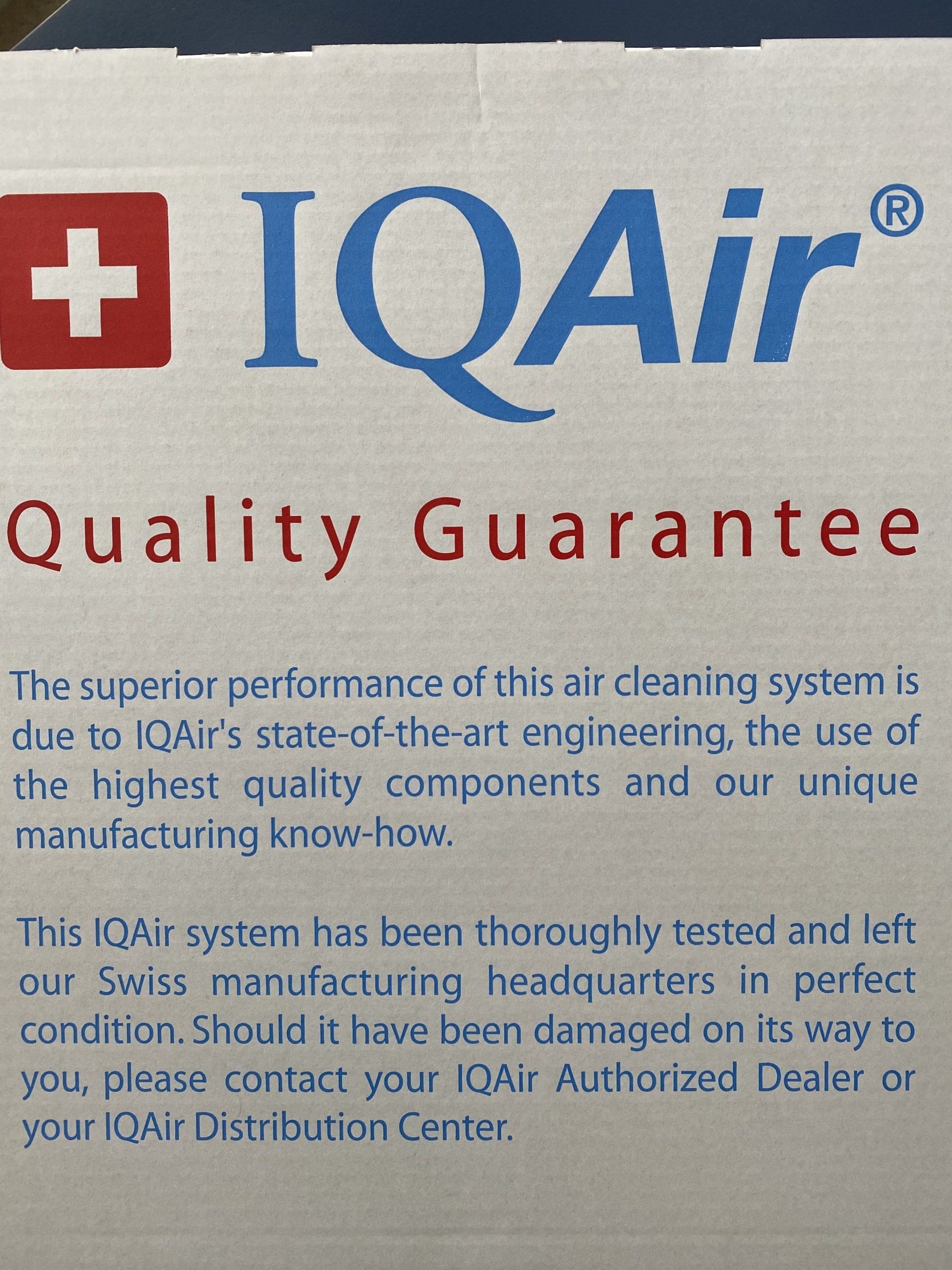 An IQAir Quality Guarantee label with a Swiss flag icon, white background, blue brand name, and red text.