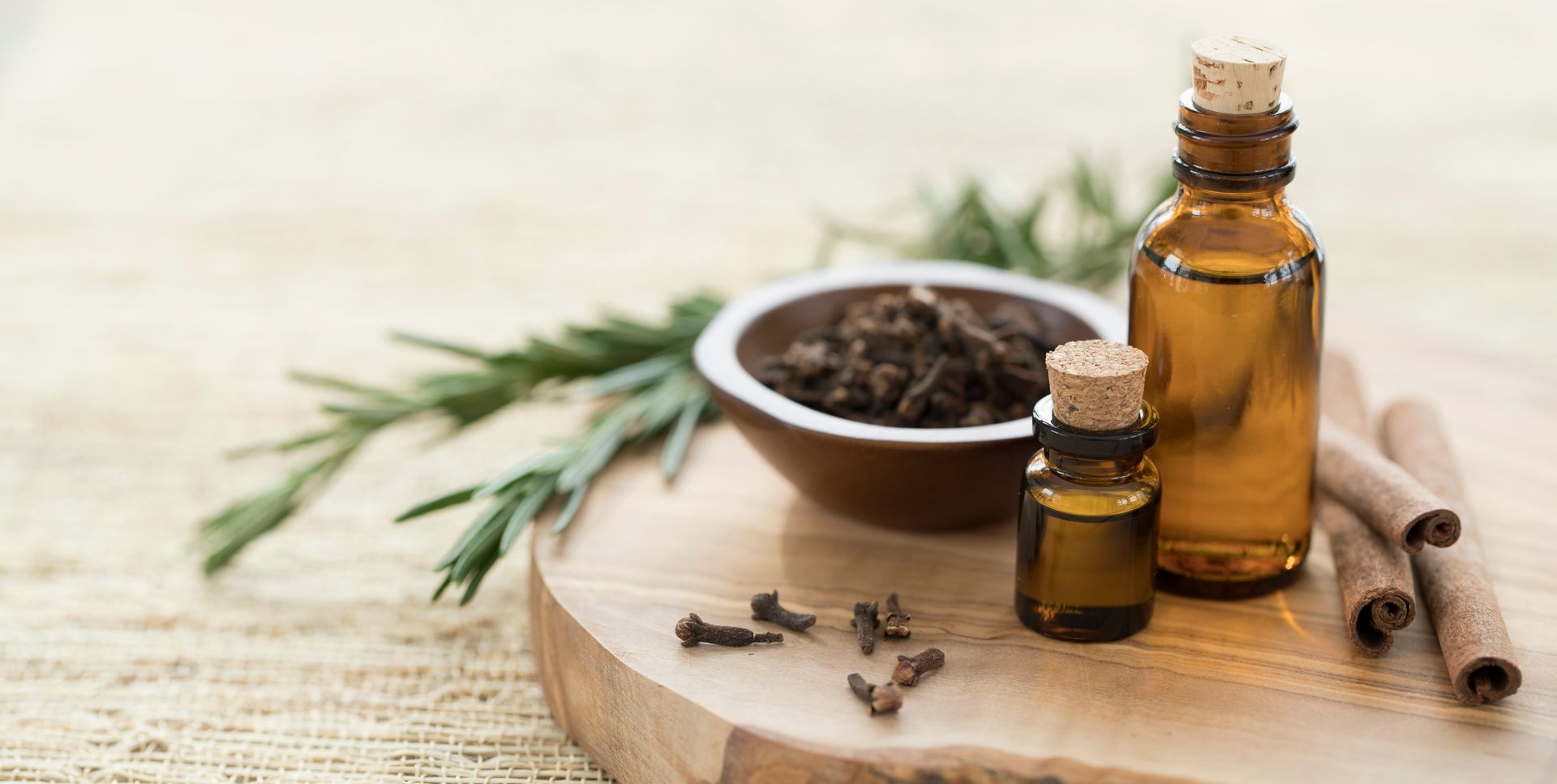 There Are Two Bottles Of Essential Oil Next To A Bowl Of Cloves And Cinnamon Sticks | Orlando, FL | Spectrum Wellcare