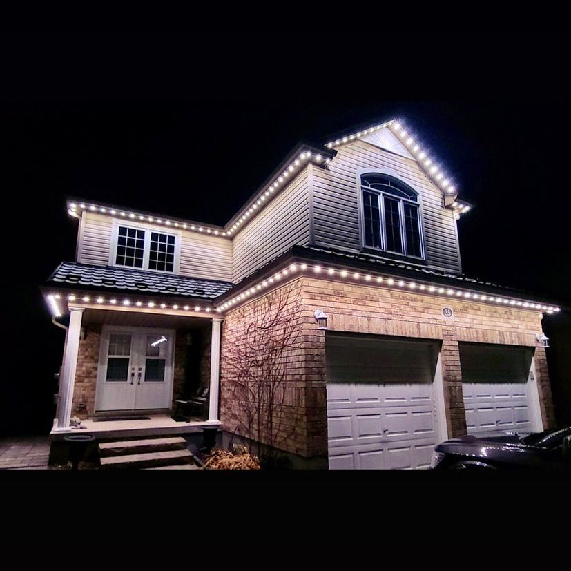 A large house with lights on it is lit up at night.