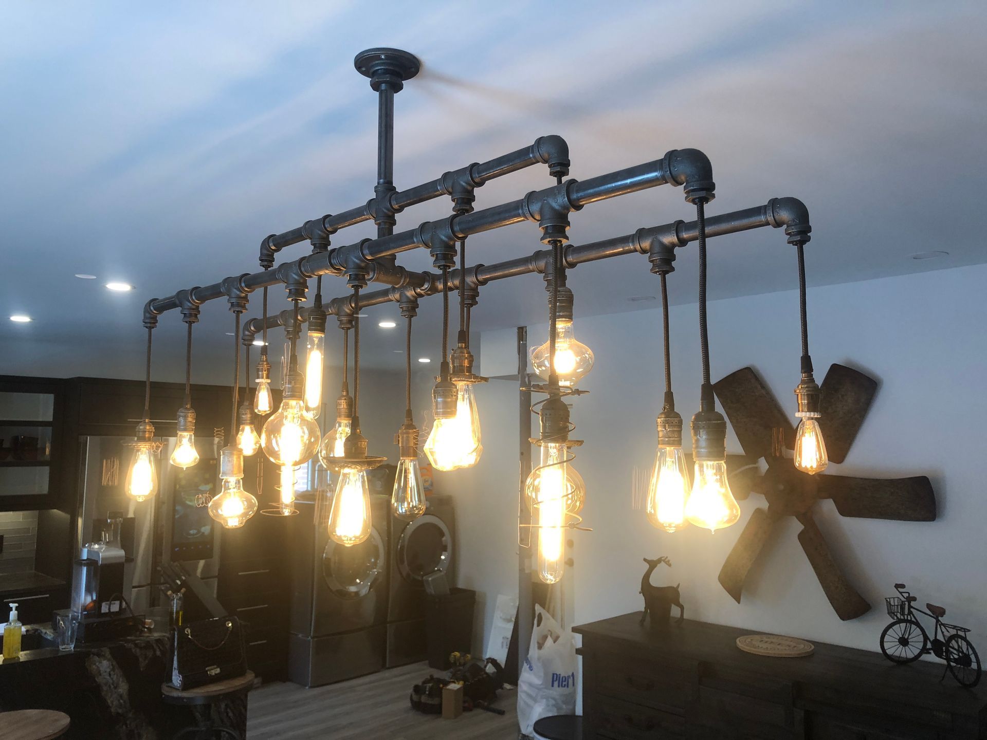 A room with a lot of lights hanging from the ceiling