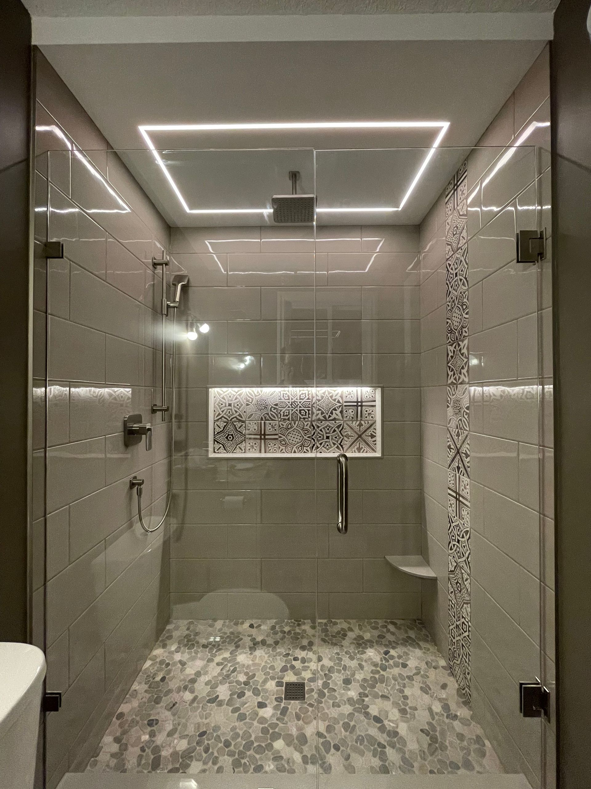 A bathroom with a walk in shower and a toilet.