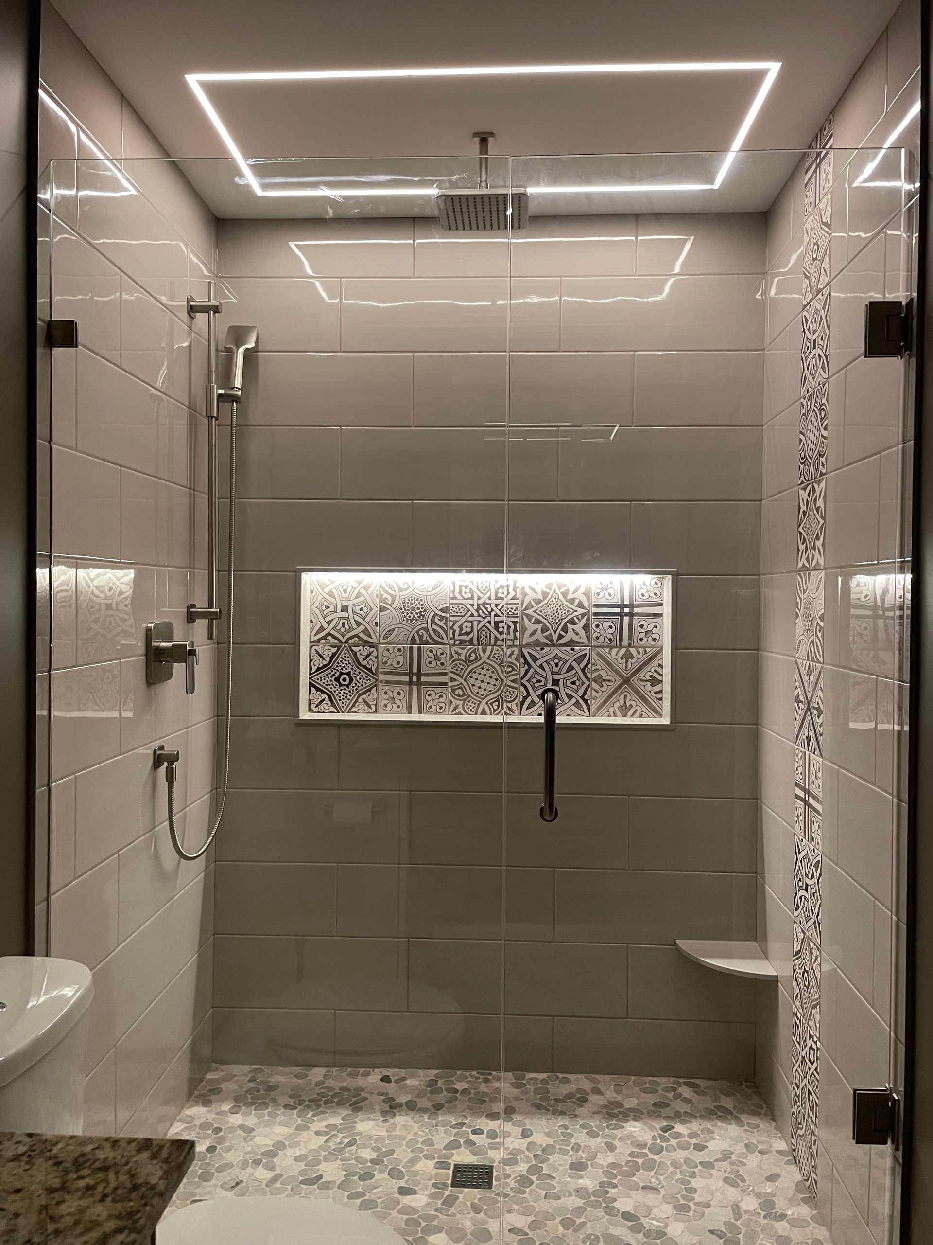 A bathroom with a walk in shower and a toilet.