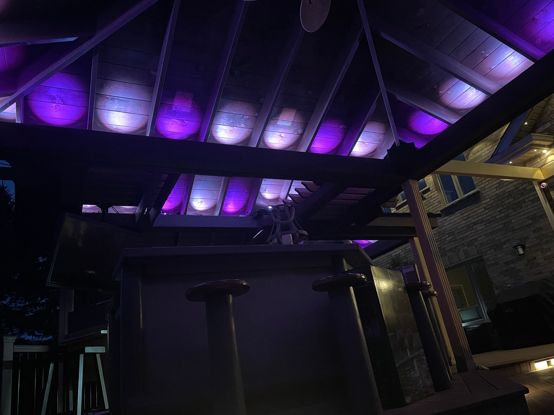 A dark room with purple lights on the ceiling
